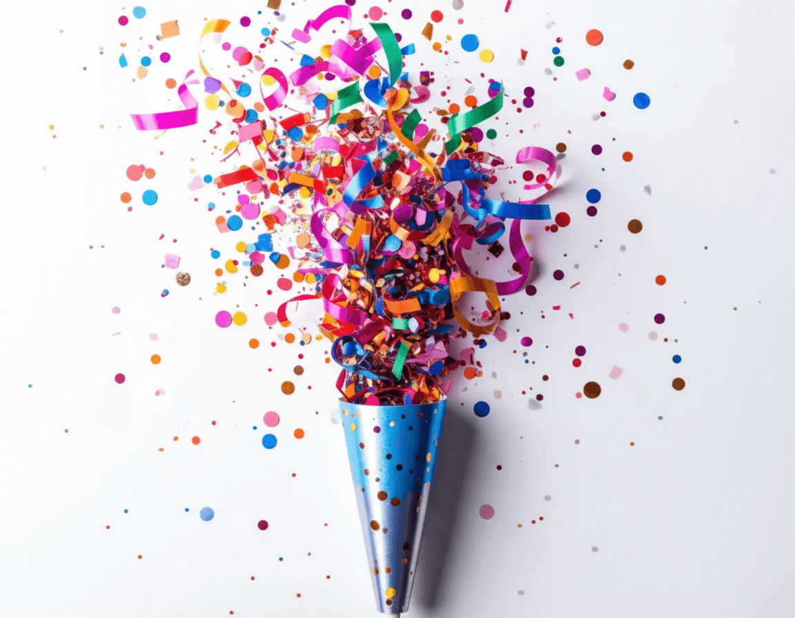 Eine Konfettikanone hat viel Konfetti auf einem weißem Hintergrund versprüht